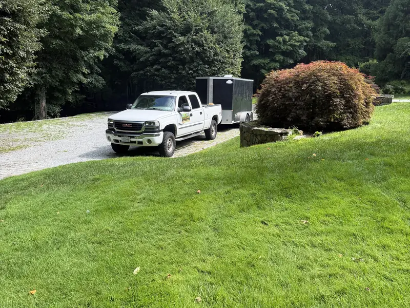 Vanguard Property Defense truck and trailer parked at a customer property