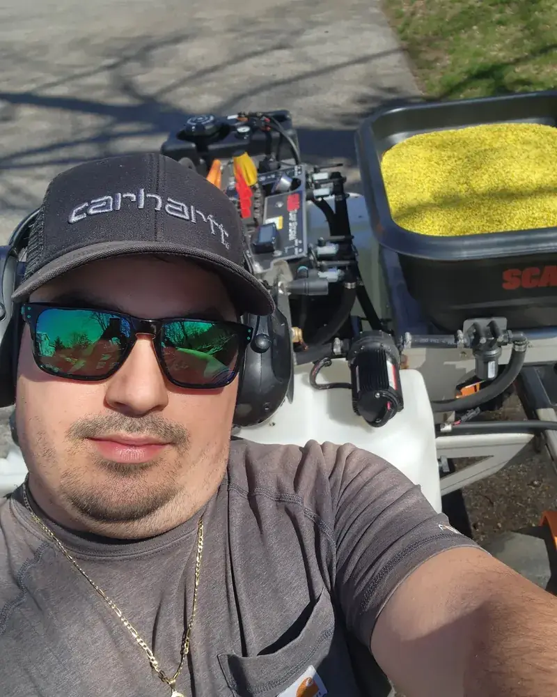 Jerry, owner of Vanguard Property Defense, on site with a loaded fertilizer spreader